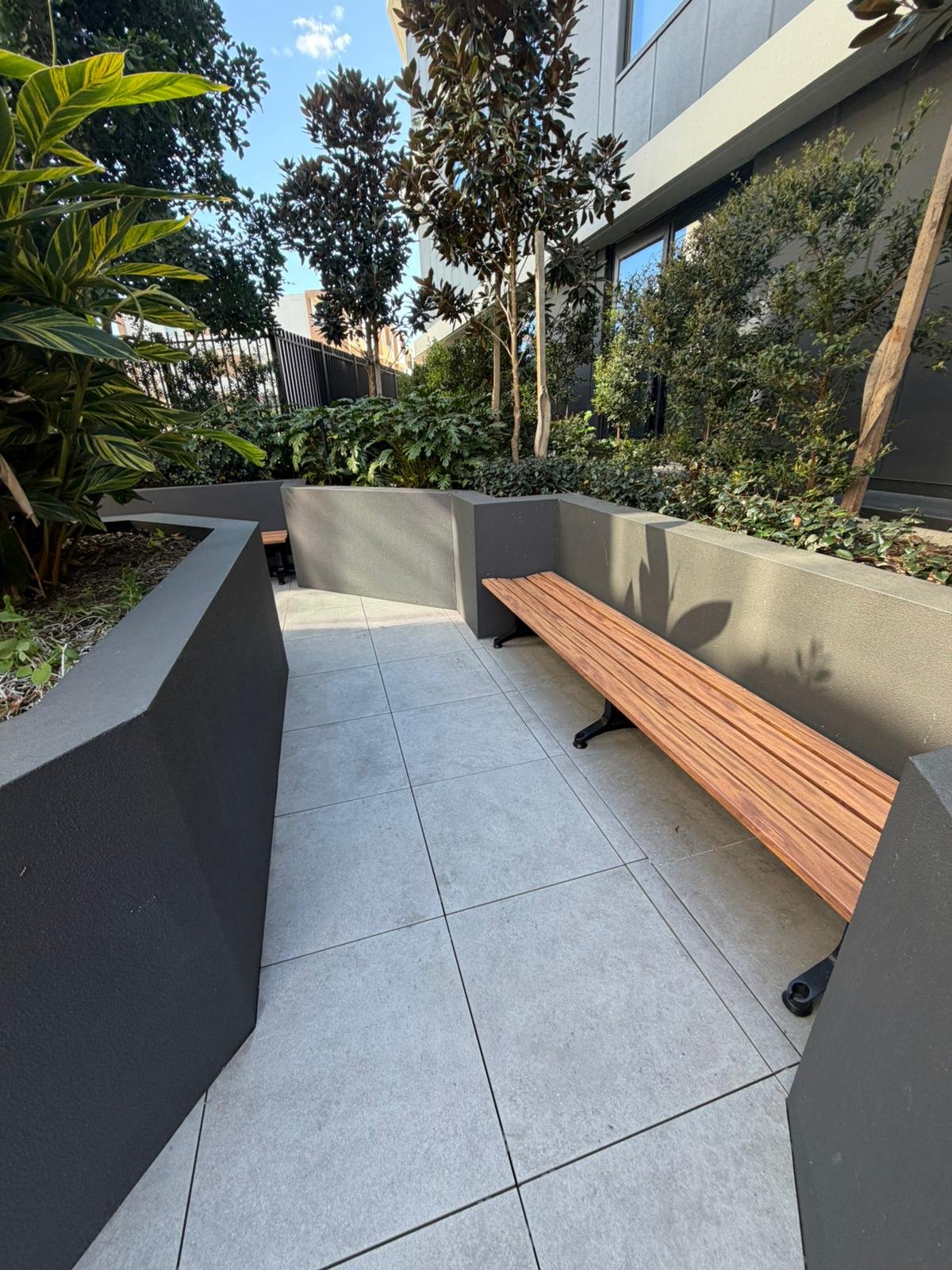 Landscaped courtyard with paved paths and shared seating.