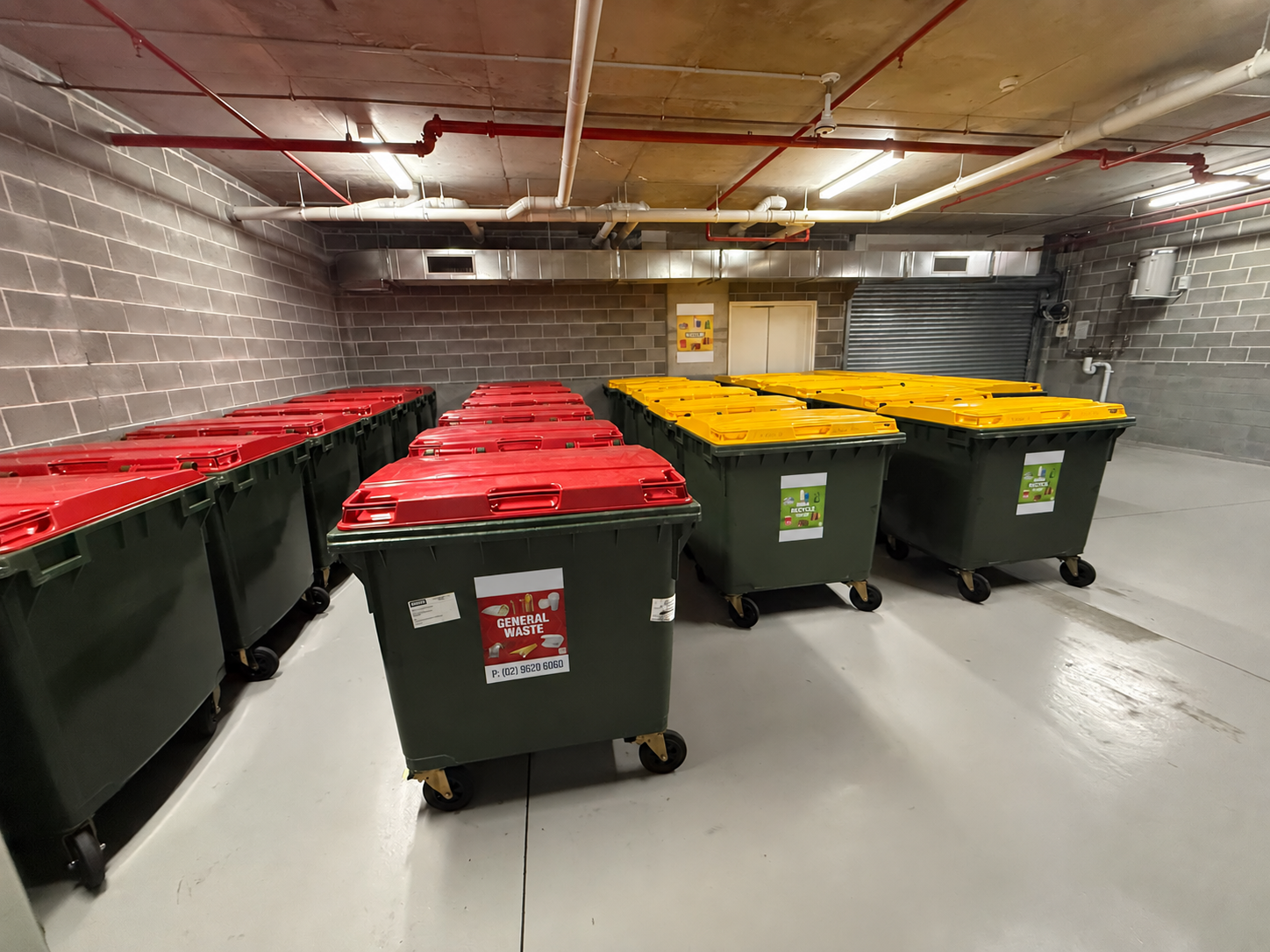 Tidy waste room with sorted bins and a clean floor.